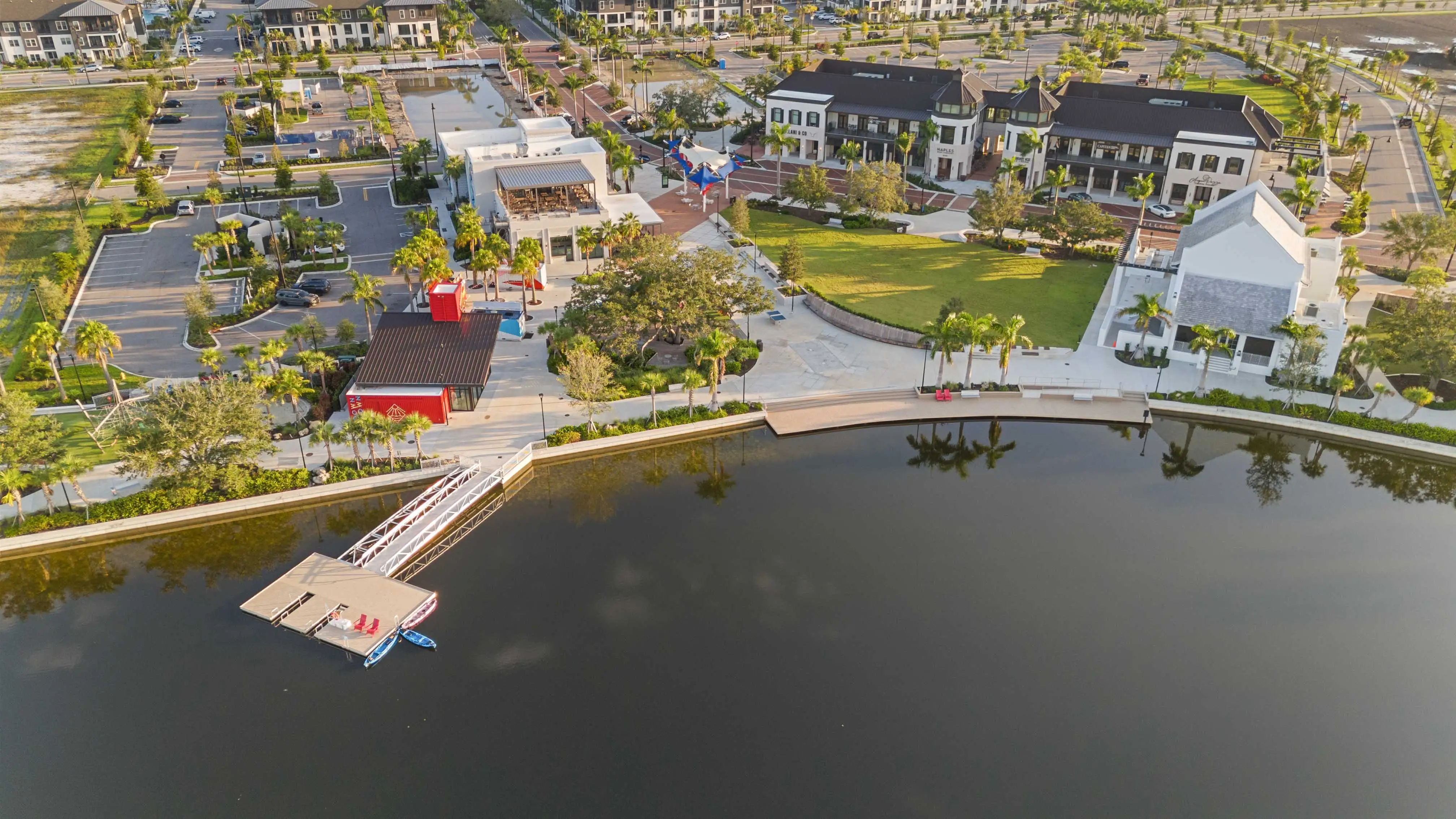 Aerial view at golden hour over Downtown Wellen: the lake, the boardwalk, and the town center, Wellen Park, Venice, Florida