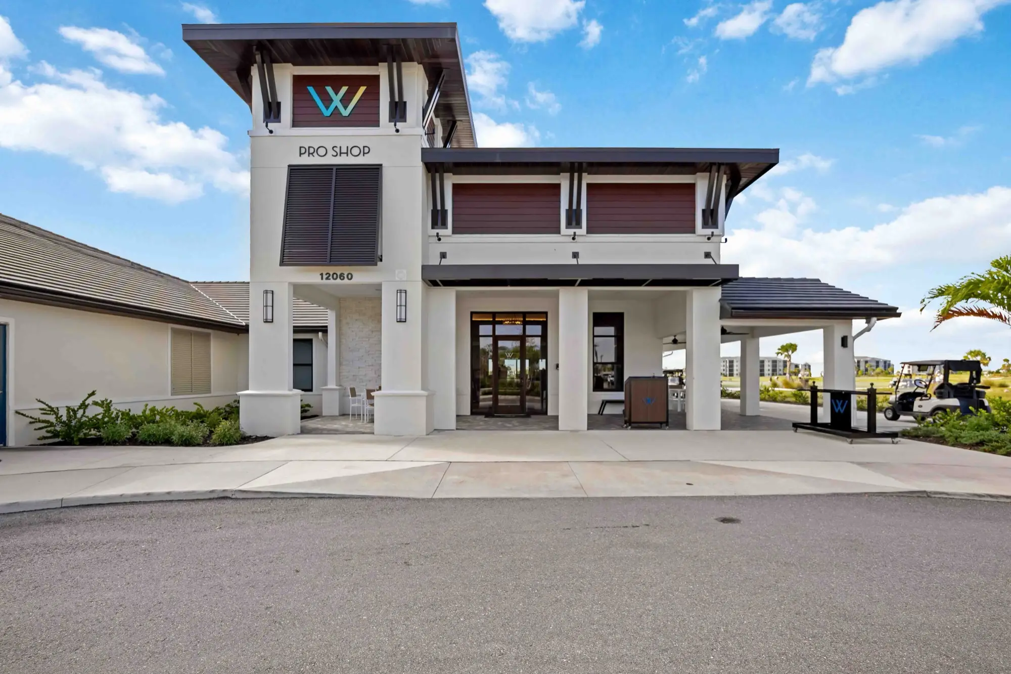 The Pro Shop building at Wellen Park Golf & Country Club, with its teal, red, and blue W monogram and covered entry